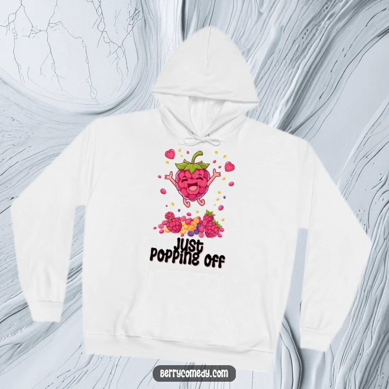 Funny hoodie featuring a delighted raspberry character in mid-air, showering colorful seeds, radiating pure, vibrant energy and happiness.